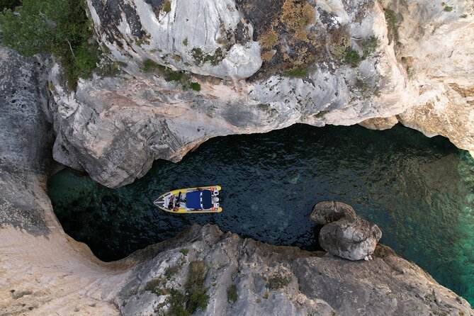 Vlore Private Boat Tour Blue Cave & Grama Bay Adventure - Bristani Bay adds bunkers to the beach scenery